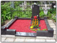 Decorating the grave with artificial or natural flowers and wreath